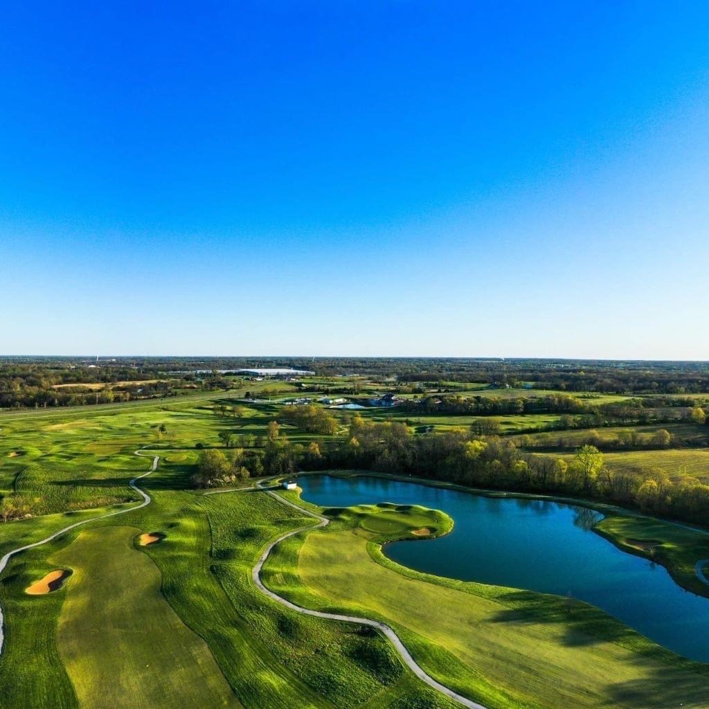 Golf course view with pond and trees